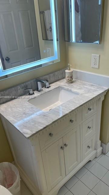 bathroom featuring tile patterned flooring and vanity