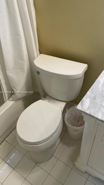 bathroom with walk in shower, tile patterned flooring, vanity, and toilet