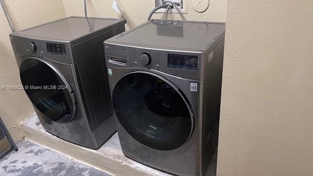 clothes washing area with washer and dryer