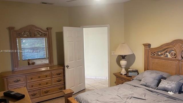 bedroom with light tile patterned floors