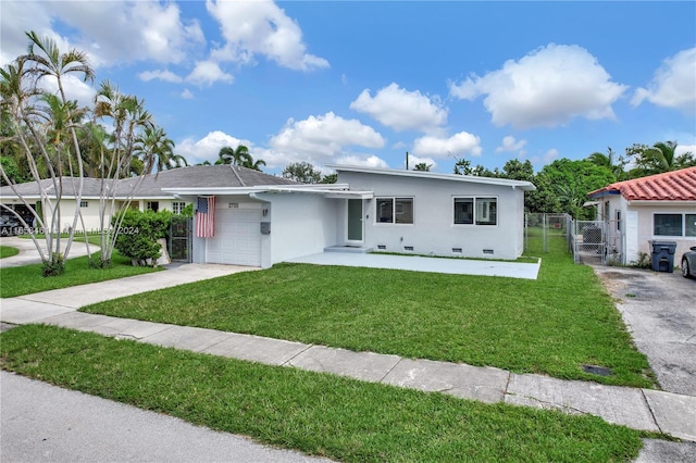 view of front of home featuring a garage and a front lawn