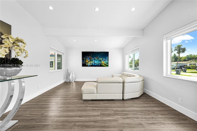 living room with a healthy amount of sunlight, vaulted ceiling with beams, and hardwood / wood-style flooring