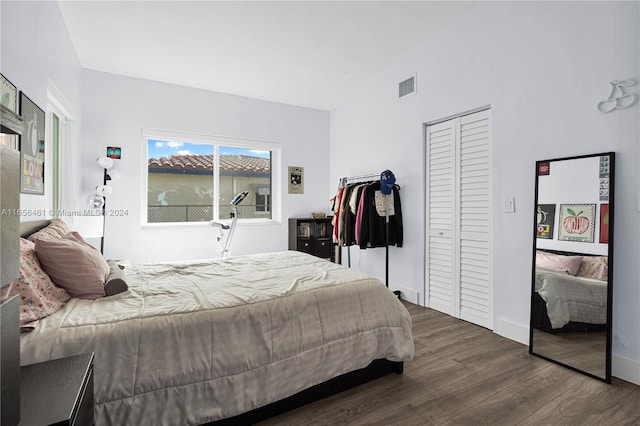 bedroom with a closet and dark wood-type flooring