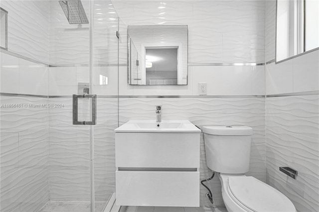 bathroom with walk in shower, vanity, tile walls, and toilet