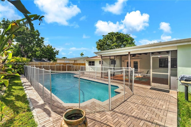 view of pool with a patio and ceiling fan