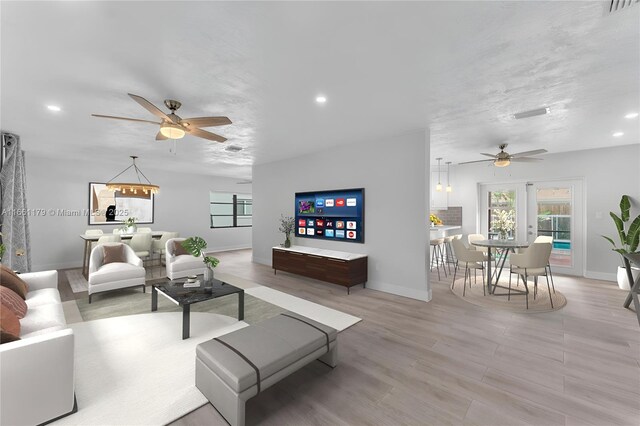 living room featuring hardwood / wood-style floors and ceiling fan