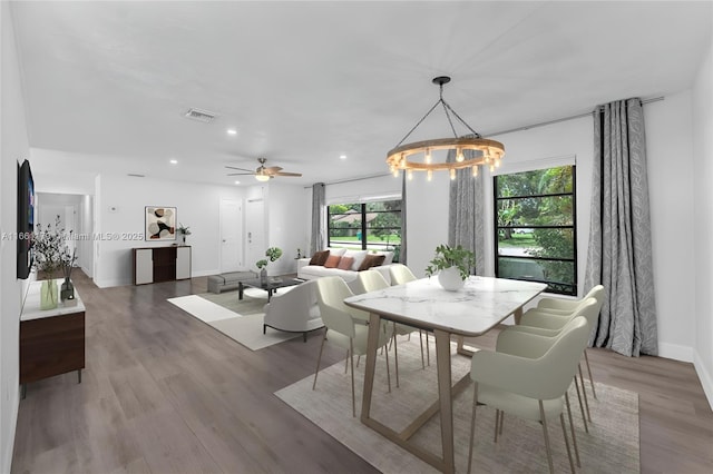 dining area with wood-type flooring and ceiling fan