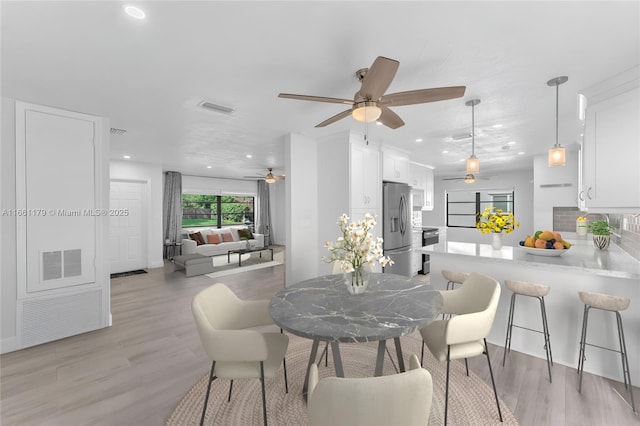 dining space with light wood-type flooring