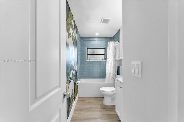 full bathroom with shower / tub combo with curtain, vanity, toilet, and hardwood / wood-style floors