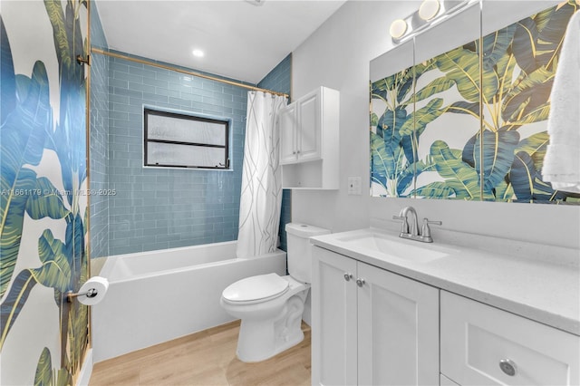 full bathroom featuring wood-type flooring, vanity, shower / bath combination with curtain, and toilet