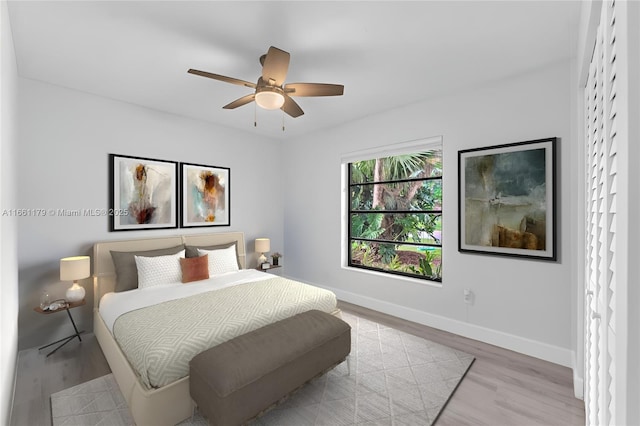 bedroom featuring ceiling fan and light hardwood / wood-style flooring