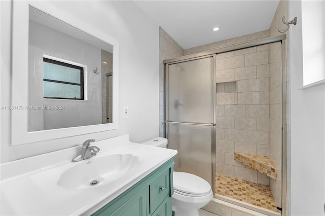 bathroom with tile patterned flooring, vanity, toilet, and an enclosed shower