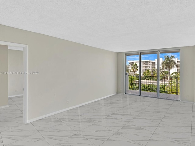 spare room with a textured ceiling