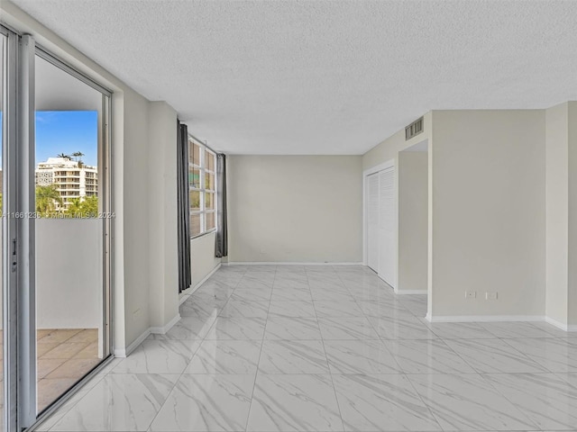 empty room featuring a textured ceiling