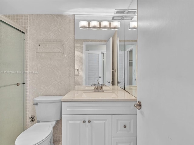 bathroom with walk in shower, vanity, and toilet