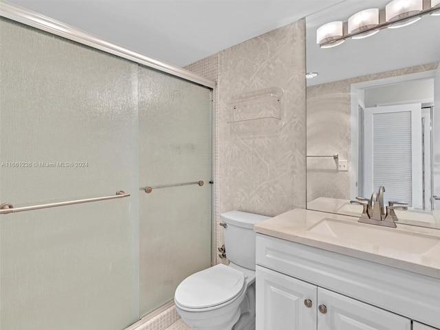 bathroom with walk in shower, vanity, and toilet