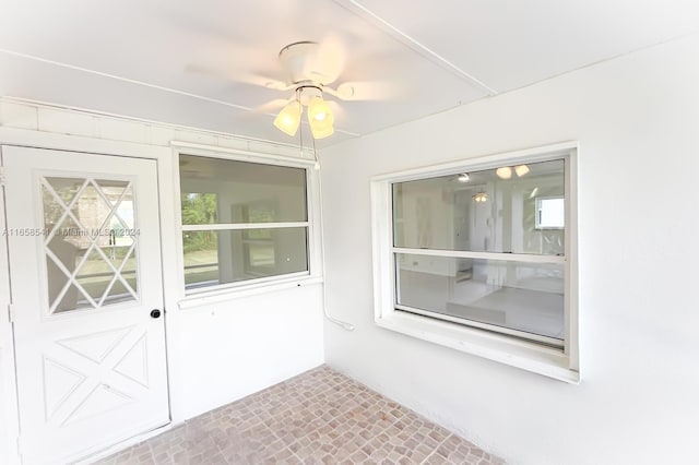 interior space featuring ceiling fan