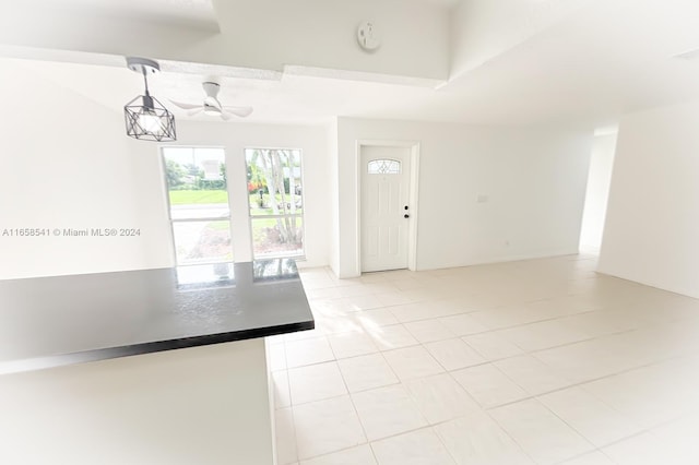 kitchen with ceiling fan, hanging light fixtures, and light tile patterned floors