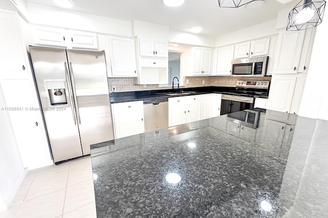 kitchen featuring appliances with stainless steel finishes, white cabinetry, sink, and pendant lighting