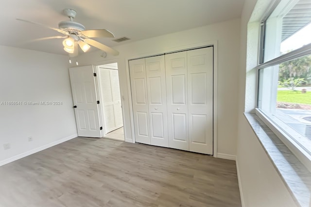 unfurnished bedroom featuring light wood-type flooring and ceiling fan