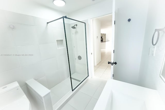 bathroom featuring walk in shower, toilet, and tile patterned floors