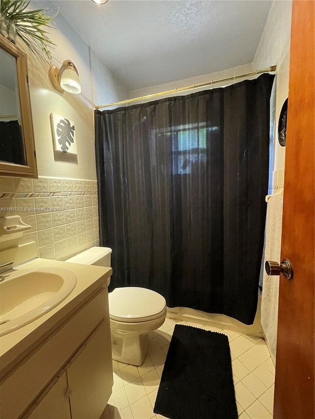 bathroom featuring vanity, a textured ceiling, tile patterned flooring, toilet, and a shower with curtain