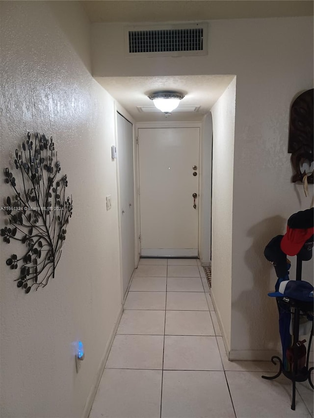 hallway with light tile patterned flooring