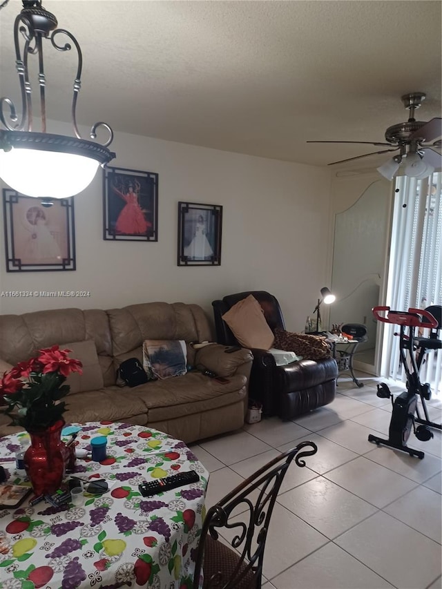 living room with ceiling fan and a textured ceiling