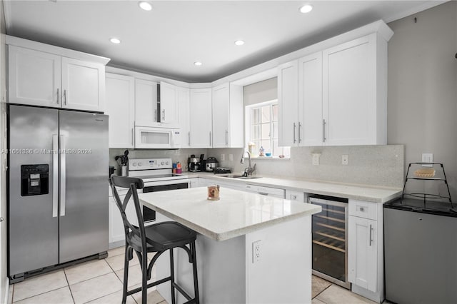 kitchen featuring white cabinetry, beverage cooler, a kitchen breakfast bar, stainless steel fridge with ice dispenser, and light tile patterned floors