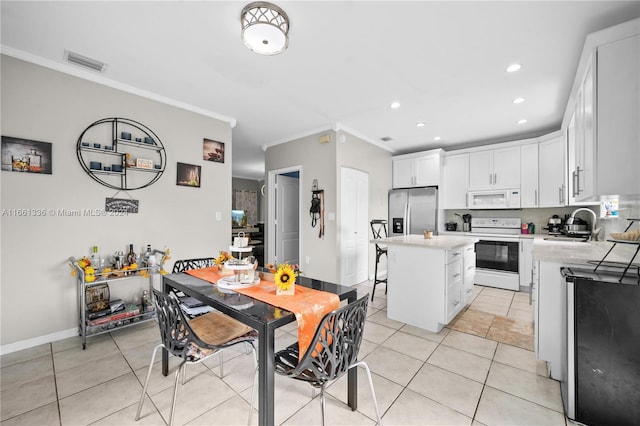 tiled dining area featuring ornamental molding