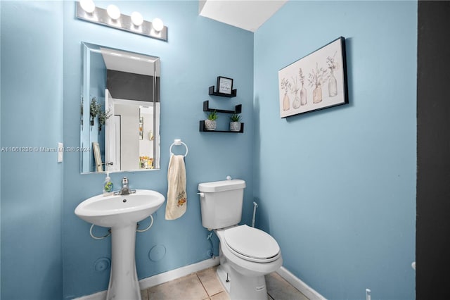 bathroom with tile patterned floors and toilet