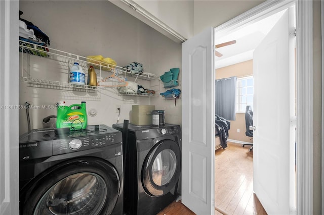 laundry area with wood-type flooring and washing machine and clothes dryer