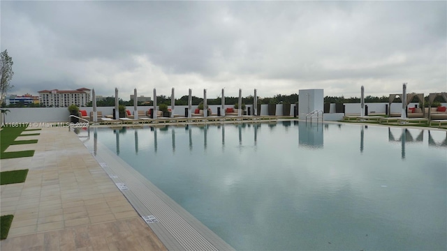 view of swimming pool with a water view