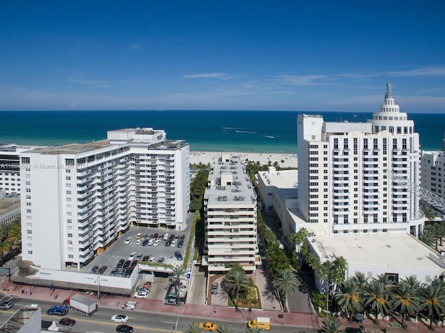 birds eye view of property with a water view and a view of the beach