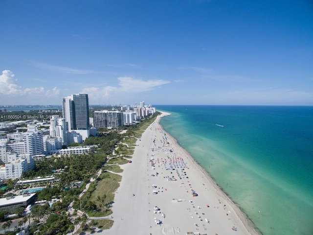 drone / aerial view featuring a water view and a beach view