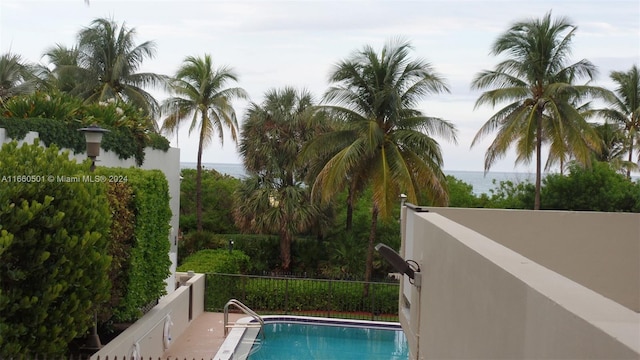 view of swimming pool with a water view