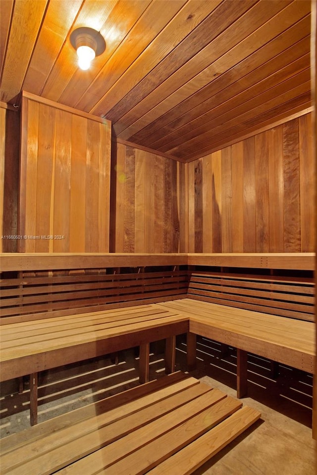 view of sauna with wood ceiling and wooden walls