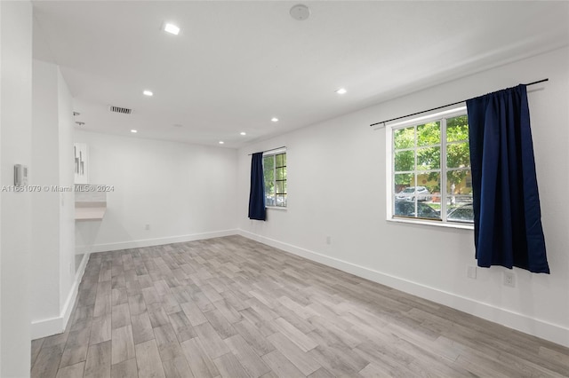 spare room featuring light hardwood / wood-style floors