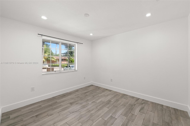 unfurnished room with light wood-type flooring