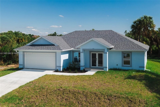 ranch-style house featuring a garage and a front yard