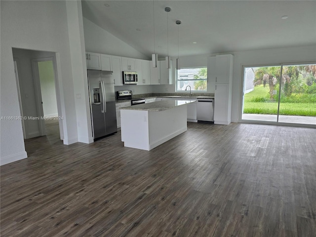 kitchen with pendant lighting, white cabinets, dark wood-type flooring, stainless steel appliances, and a center island