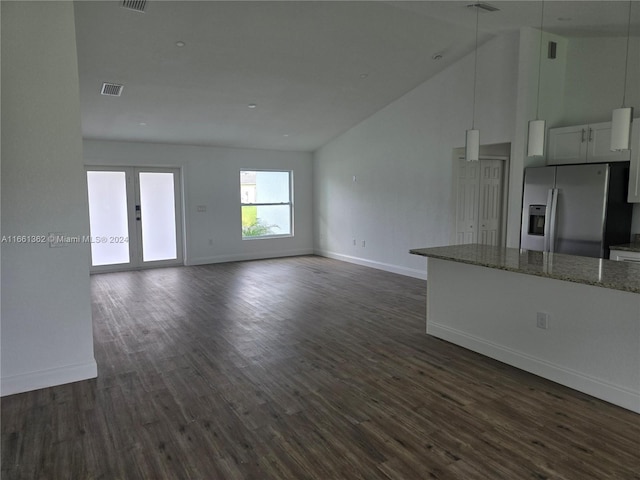 unfurnished living room with dark hardwood / wood-style flooring and high vaulted ceiling