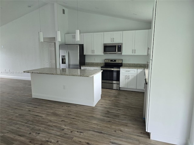 kitchen with appliances with stainless steel finishes, vaulted ceiling, dark wood-type flooring, and white cabinetry