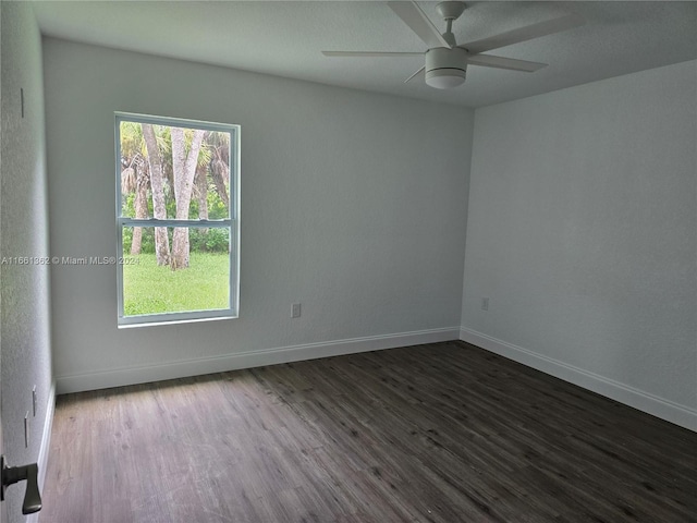 empty room featuring dark hardwood / wood-style flooring and ceiling fan