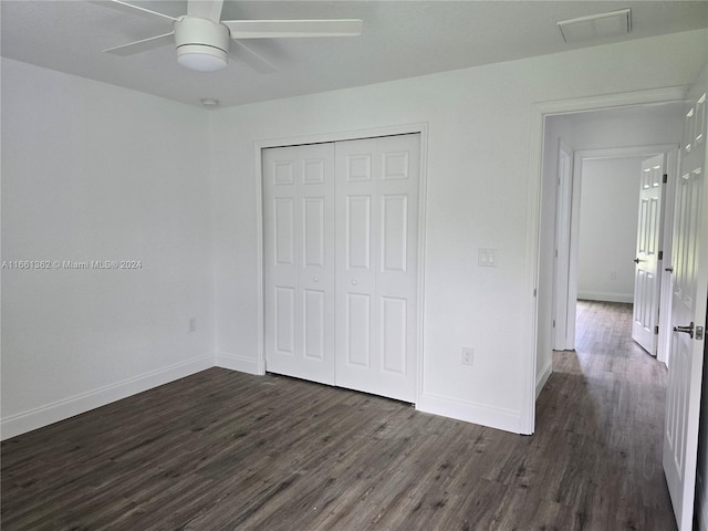 unfurnished bedroom featuring dark hardwood / wood-style floors, ceiling fan, and a closet