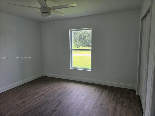 empty room featuring ceiling fan and dark wood-type flooring