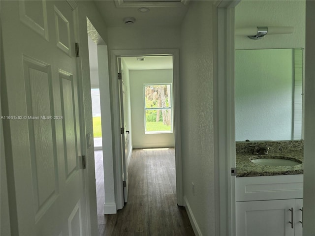 hallway with dark hardwood / wood-style flooring and sink