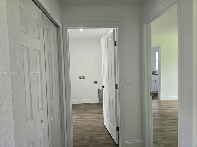 corridor with dark hardwood / wood-style flooring