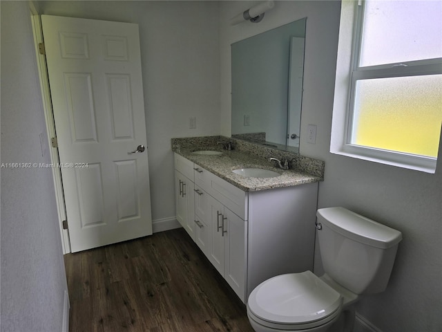 bathroom with hardwood / wood-style flooring, vanity, and toilet