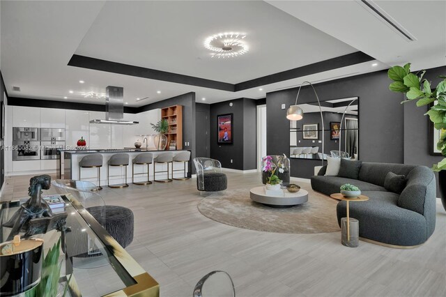 living room featuring a tray ceiling